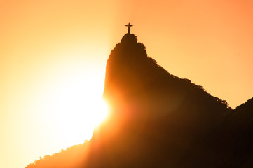 Wall Mural - The famous Rio de Janeiro landmark - Christ the Redeemer statue on Corcovado mountain. Silhouette by sunset