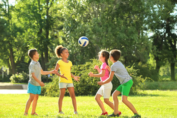 Wall Mural - Cute children playing with ball in park