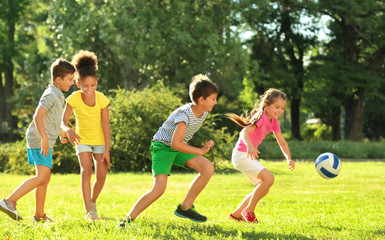 cute children playing with ball in park