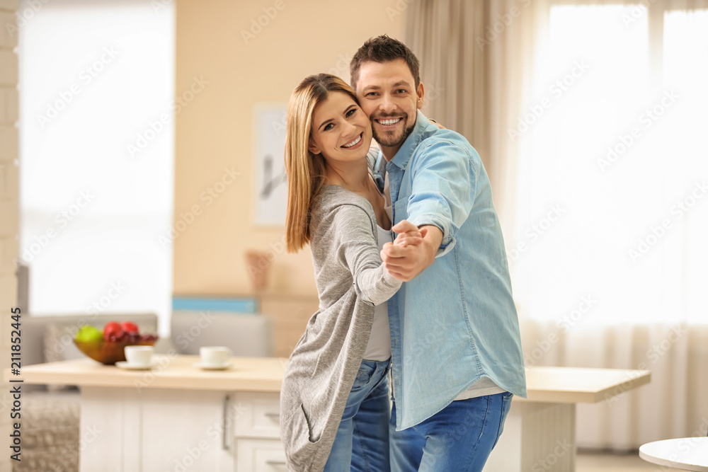 Happy couple dancing at home