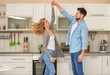 © Africa Studio - Happy couple dancing in kitchen