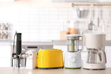 Wall Mural - Kitchen appliances on table against blurred background