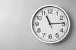 Modern clock on grey background, top view. Time management