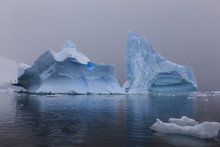 Blue Icebergs In Snowy Weather, From Sea Level, Waterboat Point, Paradise Bay, Graham Land, Antarctic Peninsula, Antarctica