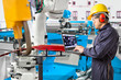 © kinwun - Engineer using laptop computer maintenance robot grip automotive workpiece position in manufacturing, Smart factory concept