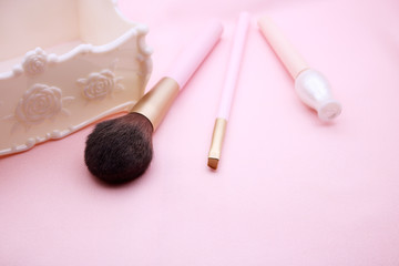 Make up products on pink background.