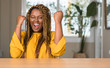 © Krakenimages.com - African american woman at home screaming proud and celebrating victory and success very excited, cheering emotion