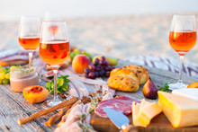 Picnic On Beach At Sunset In Boho Style. Romantic Dinner, Friends Party, Summertime, Food And Drink Concept