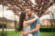 © Aleksandr - Couple kissing in the spring blossom tress
