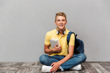 Wall Mural - Portrait of a smiling casual teenage boy with backpack