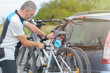 © Monika Wisniewska - Man loading bicycles on the bike rack
