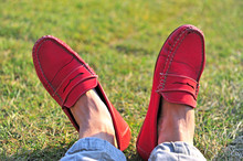 Mens Legs In Red Moccasins On The Grass