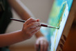 canvas print picture - Preschool girl painting in art class. Close up photo brush in hand