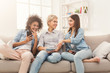 © Prostock-studio - Three female friends using smartphone