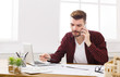 © Prostock-studio - Young concentrated architect has mobile phone talk