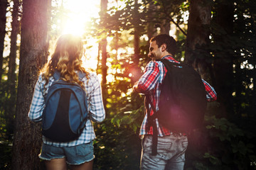 Wall Mural - group of backpacking hikers going for forest trekking
