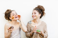 Fashion Blogger Twins Applying Face Masks, White Background