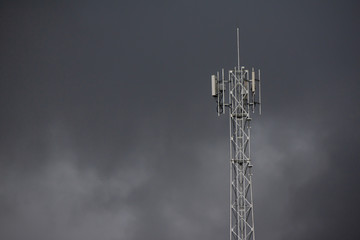 The radio transmitter under the dark sky that is falling rain.