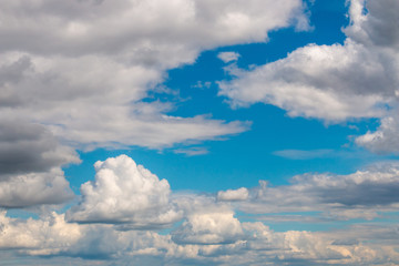 Scenic view at blue sky with clouds. Abstract nature background. Dramatic sky with fluffy clouds. Sunny day.