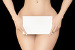 © PixlMakr - Female covers her pubic area by white empty sign on black background