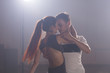 © satura_ - Young love couple dancing social danse kizomba or bachata.