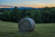 Hay In Farm Field With Mountains And Sunset Looking Out Towards The Shenandoah National Park.