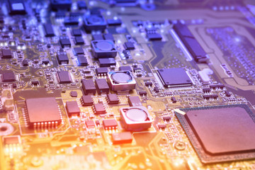 Closeup on electronic board in hardware repair shop, blurred and toned image