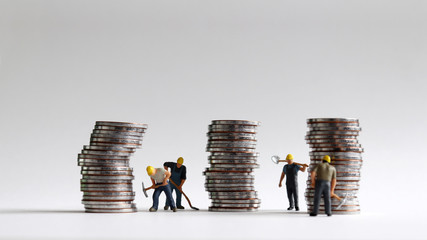 Wall Mural - Miniature workers and three pile of coins.