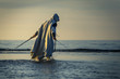 © bint87 - Portrait of assassin in white costume with the sword at the sea. He is posing near water during sunset, soft light.