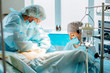 © Iryna - Process of Gynecological surgery operation. Female doctors performing gynecological operation at the hospital healthcare medicine gynecology treatment curing help assistance experience. Real scene