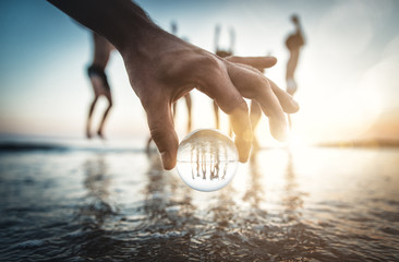 Artistic portrait of friends with reflection inside a glass sphere