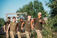 Multiethnic Soldiers In Military Uniform Running On Range