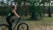 © ivandanru - Fat bike also called fatbike or fat-tire bike in summer riding in the forest. Beautiful girl and her bicycle in the forest. She rolls her bike and poses to the operator.