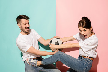 The unhappy and angry fans on colored blue and pink background.