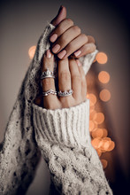 Hands With Silver Rings On Golden Bokeh Lights Background