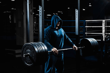 Wall Mural - Strong man working in gym