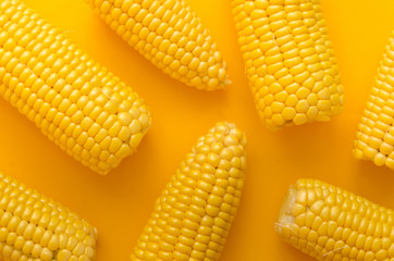 Wall Mural - Bright ripe yellow corn on a yellow background in the style of pop art.