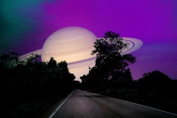 Wall Mural - Saturn near earth on night sky over the country road