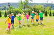 © oksix - Group of kids in colorful t-shirts outdoor