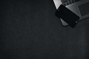 Top view smartphone with laptop keyboard on black background, Technology