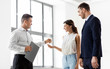 © Syda Productions - real estate business, sale and people concept - realtor giving key to customers or new office owner