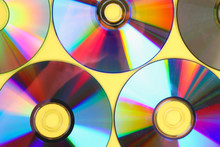 Piles Of Old And Dirty CDs,DVD On Pastel Background. Used And Dusty Disk With Copy Space For Add Text.