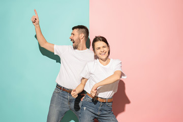 A couple of young man and woman dancing hip-hop at studio.