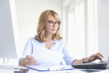 Wall Mural - Professional woman working at the office