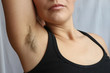 Female hairy armpit, unshaved underarms new fashion trend concept.