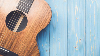 New brown guitar on wooden board