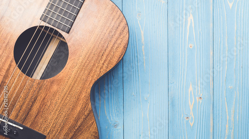 New brown guitar on wooden board Fototapet