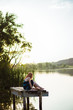 © ADDICTIVE STOCK - Sensual young woman sitting on pier