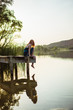 © ADDICTIVE STOCK - Sensual young woman sitting on pier