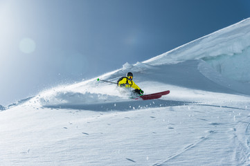 Wall Mural - The total length of skiing on fresh snow powder. Professional skier outside the track on a sunny day